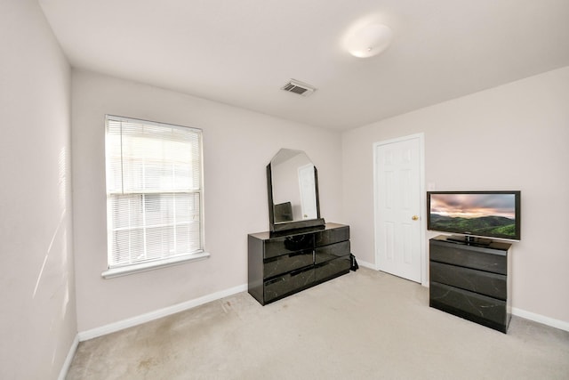 interior space with visible vents, carpet flooring, baseboards, and arched walkways