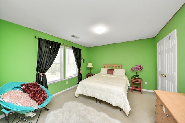 carpeted bedroom featuring visible vents and baseboards