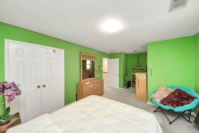 carpeted bedroom featuring a closet, baseboards, and visible vents