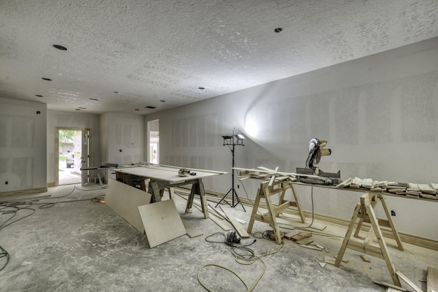 game room featuring a textured ceiling