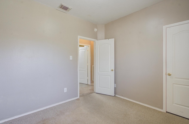 18303 Melissa Springs Dr, Tomball, TX 77375 - unfurnished bedroom with light colored carpet, baseboards, and visible vents