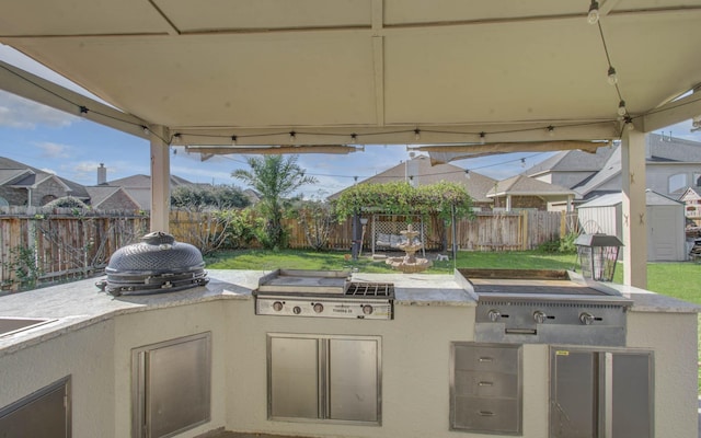 18303 Melissa Springs Dr, Tomball, TX 77375 - view of patio / terrace with a storage shed, an outbuilding, a fenced backyard, and area for grilling