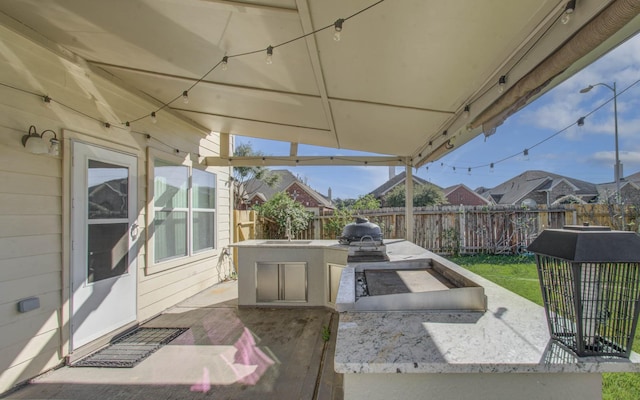 18303 Melissa Springs Dr, Tomball, TX 77375 - view of patio / terrace with a fenced backyard, a sink, area for grilling, and an outdoor kitchen