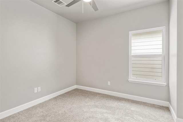 unfurnished room with carpet floors, ceiling fan, visible vents, and a healthy amount of sunlight