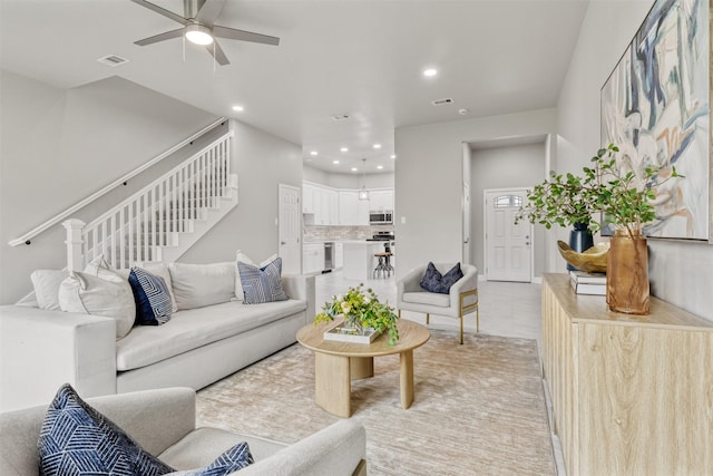 8159 Crestview Dr, Houston, TX 77028 - living area with ceiling fan, stairway, and recessed lighting