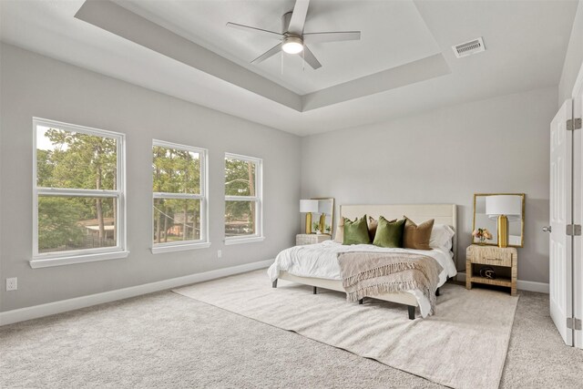 8159 Crestview Dr, Houston, TX 77028 - bedroom with a raised ceiling, light carpet, baseboards, and ceiling fan
