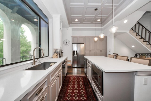 403 W Pierce St W, Houston, TX 77019 - kitchen with appliances with stainless steel finishes, a sink, light countertops, coffered ceiling, and a center island