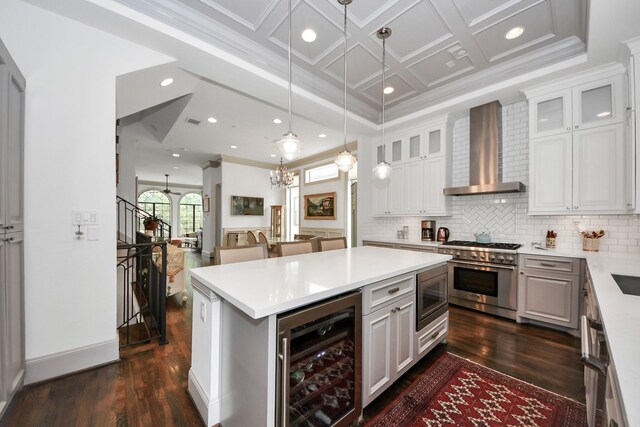 403 W Pierce St W, Houston, TX 77019 - kitchen with beverage cooler, wall chimney range hood, appliances with stainless steel finishes, dark wood finished floors, and crown molding