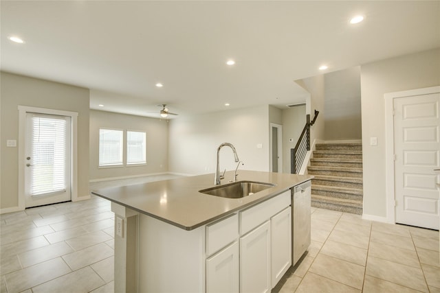kitchen featuring ceiling fan, a sink, open floor plan, recessed lighting, and white cabinetry