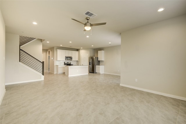 unfurnished living room featuring visible vents, a ceiling fan, baseboards, and recessed lighting
