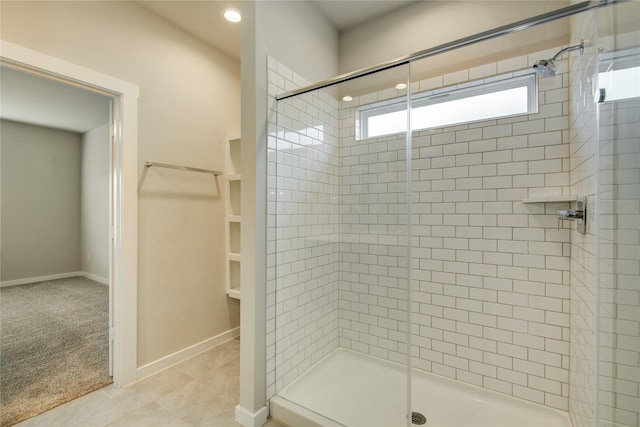 bathroom with tile patterned floors, baseboards, a shower stall, and recessed lighting