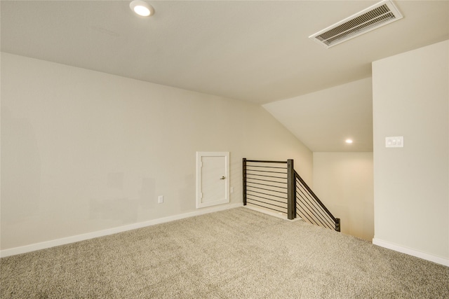 additional living space with visible vents, baseboards, recessed lighting, carpet flooring, and vaulted ceiling
