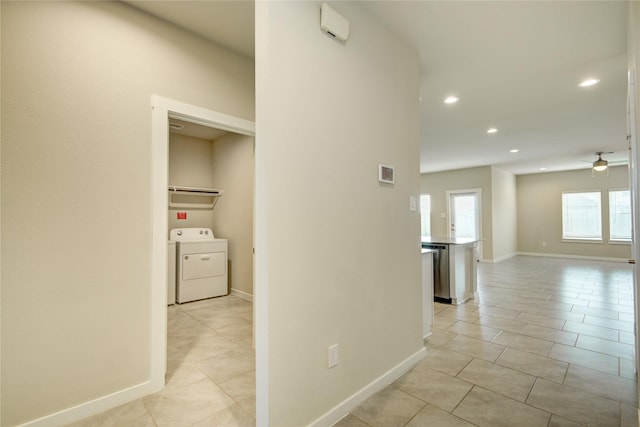 corridor featuring light tile patterned floors, baseboards, recessed lighting, and washer / clothes dryer