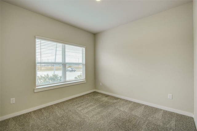 carpeted empty room with baseboards