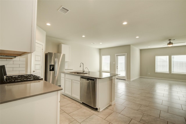 kitchen featuring plenty of natural light, a sink, appliances with stainless steel finishes, and open floor plan
