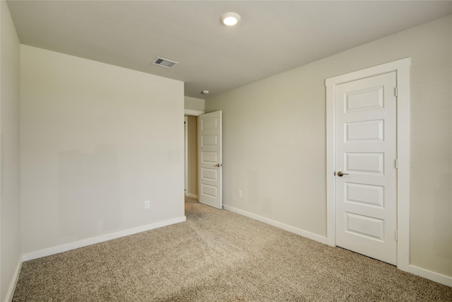 carpeted empty room with recessed lighting, baseboards, and visible vents