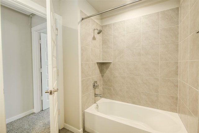 full bath featuring baseboards and washtub / shower combination