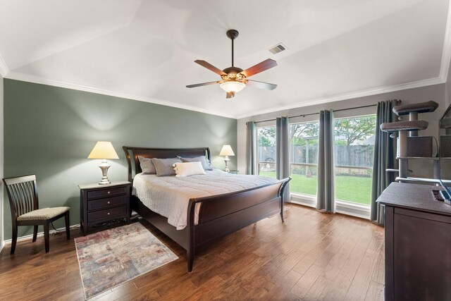 bedroom with crown molding, visible vents, and wood finished floors