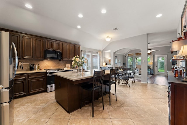 kitchen featuring a ceiling fan, backsplash, visible vents, light countertops, and stainless steel appliances