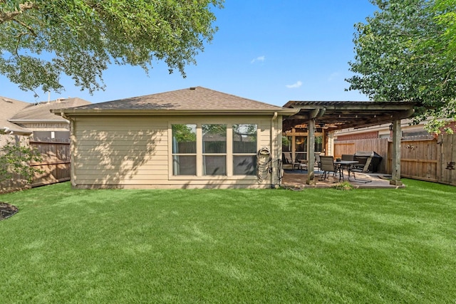 rear view of property with a lawn, a pergola, a fenced backyard, and a patio area