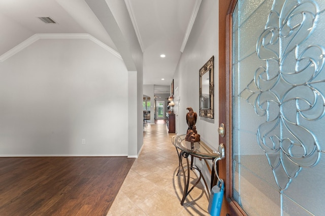 foyer featuring visible vents, crown molding, baseboards, recessed lighting, and vaulted ceiling