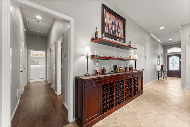 bar with separate washer and dryer, a dry bar, baseboards, and recessed lighting