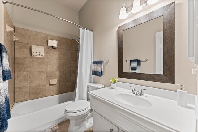 bathroom with toilet, shower / bath combination with curtain, and vanity