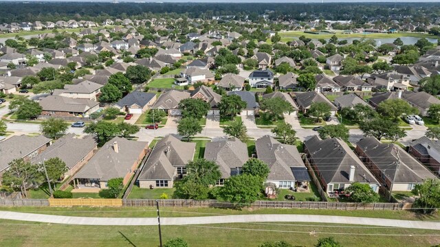 drone / aerial view featuring a water view and a residential view
