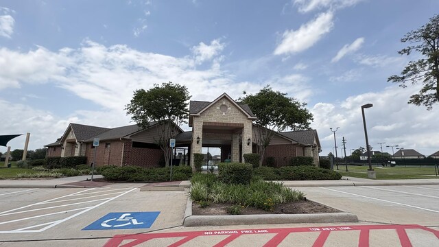 view of building exterior featuring uncovered parking