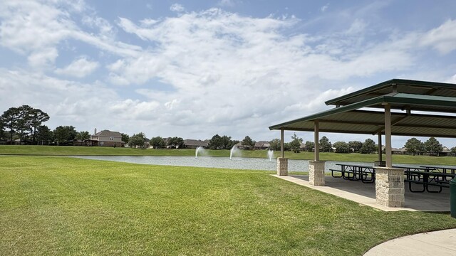 view of property's community featuring a lawn, a gazebo, and a water view