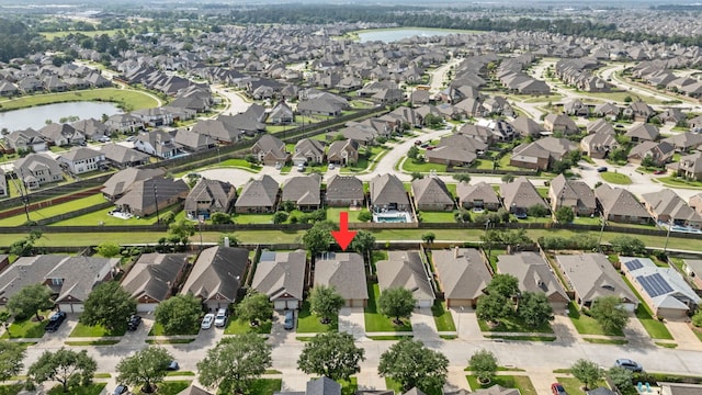 birds eye view of property featuring a residential view and a water view