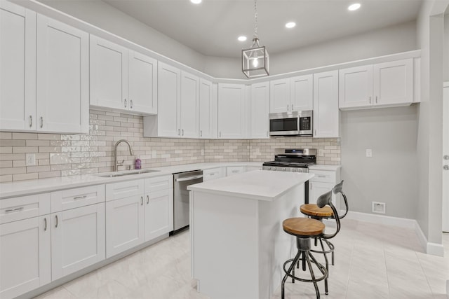 8161 Crestview Dr, Houston, TX 77028 - kitchen with stainless steel appliances, a sink, light countertops, white cabinetry, and decorative backsplash