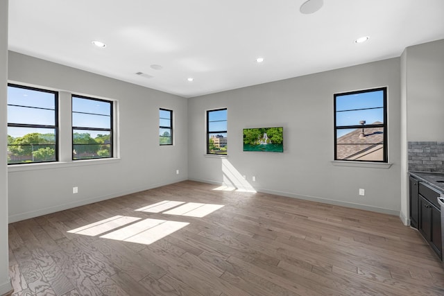 empty room with baseboards, recessed lighting, light wood-style flooring, and visible vents