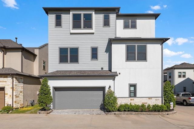 view of front of property featuring an attached garage, driveway, and stucco siding
