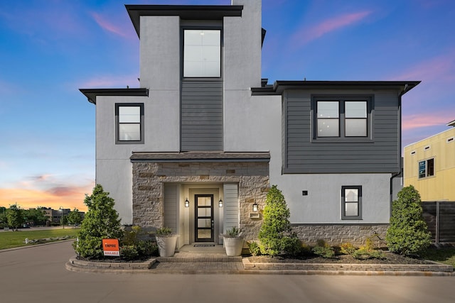 modern home with stucco siding and stone siding
