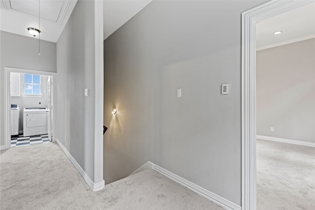 hall featuring baseboards, carpet, attic access, and independent washer and dryer
