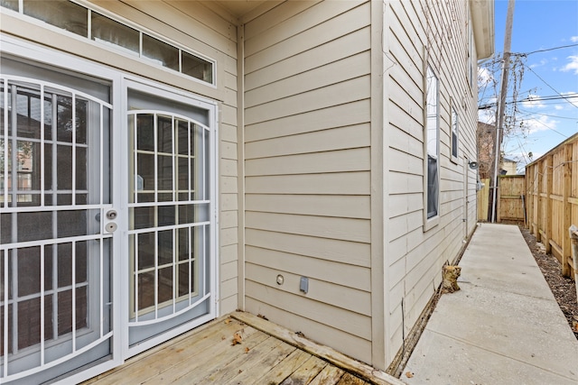 entrance to property featuring fence