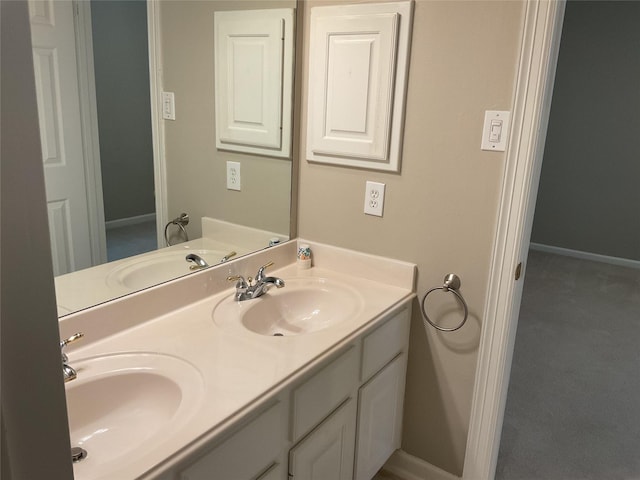 bathroom featuring a sink, baseboards, and double vanity