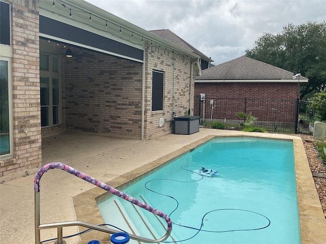 view of pool with a fenced in pool, ceiling fan, a patio area, and fence