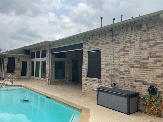 back of house featuring a patio and an outdoor pool
