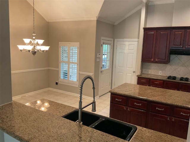 kitchen with a sink, black stovetop, lofted ceiling, and a notable chandelier