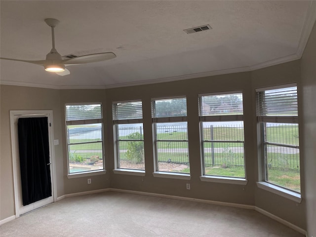 unfurnished room with baseboards, visible vents, ornamental molding, and light colored carpet