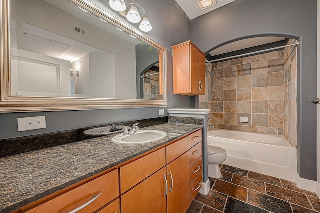 bathroom with visible vents, shower / washtub combination, vanity, toilet, and stone tile floors