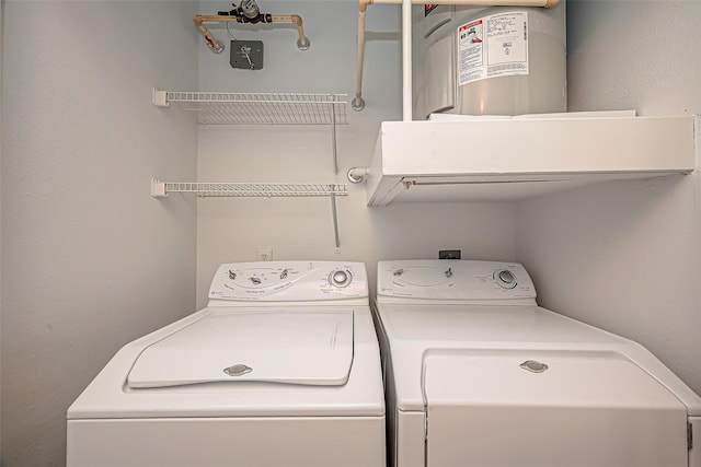 clothes washing area with washer and dryer and laundry area