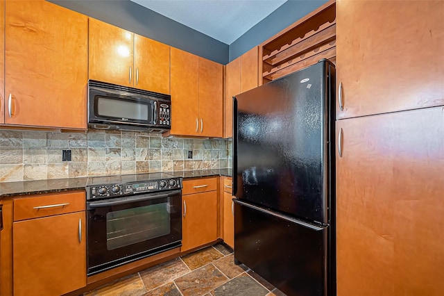 kitchen featuring backsplash, brown cabinetry, stone finish floor, and black appliances