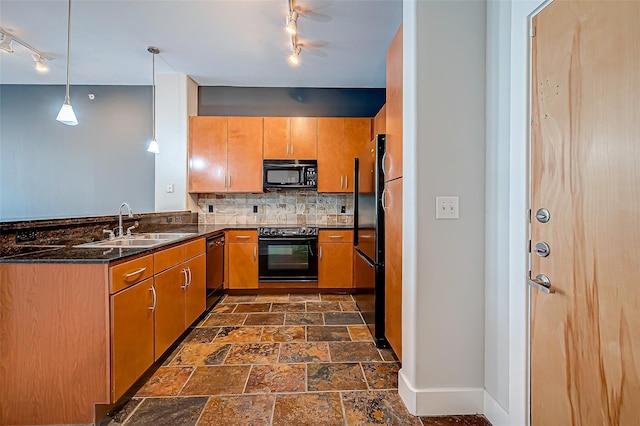 kitchen featuring backsplash, a sink, track lighting, baseboards, and black appliances