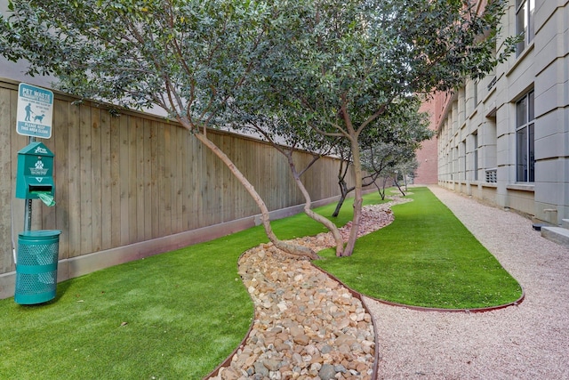 view of home's community with fence