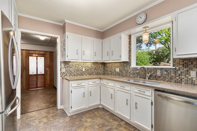 kitchen featuring a sink, white cabinets, stone finish floor, and stainless steel appliances