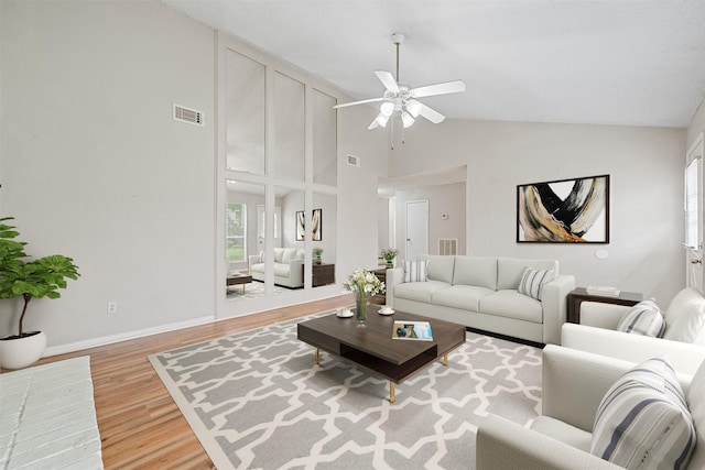 living room featuring visible vents, wood finished floors, high vaulted ceiling, a ceiling fan, and a wealth of natural light
