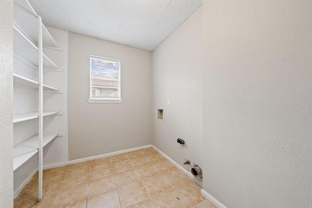 laundry area with gas dryer hookup, laundry area, a textured ceiling, tile patterned floors, and hookup for a washing machine
